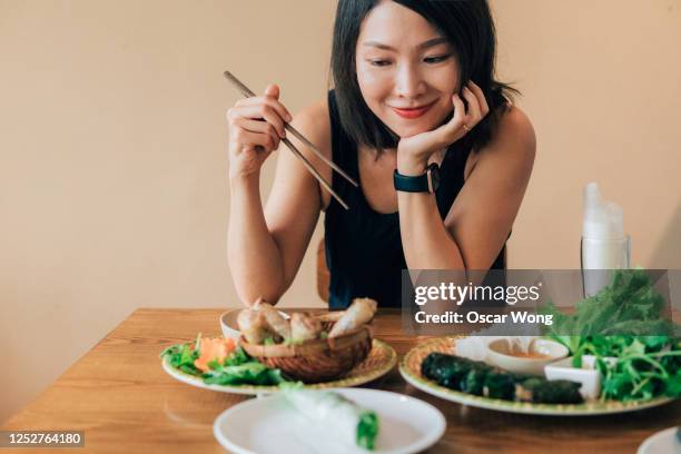 tourist tasting local vietnamese food - spring roll stock pictures, royalty-free photos & images