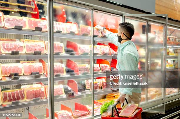 young man shopping at grocery store using mask - meat packaging imagens e fotografias de stock