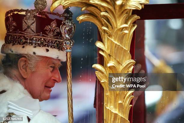 Queen Camilla and King Charles III travel in the Gold State Coach, back to Buckingham Palace from Westminster Abbey on May 6, 2023 in London,...