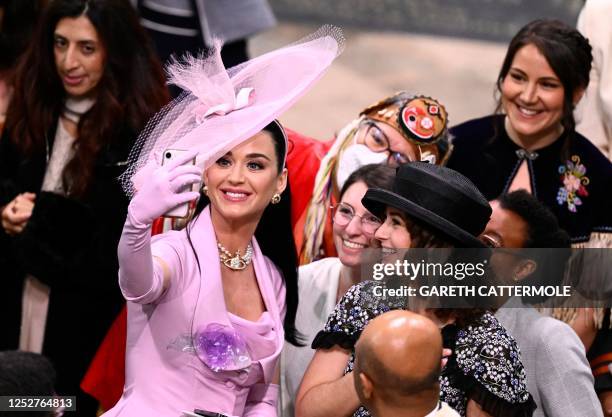 American singer-songwriter Katy Perry takes selfie photos with guests at Westminster Abbey in central London on May 6 during the coronations of...