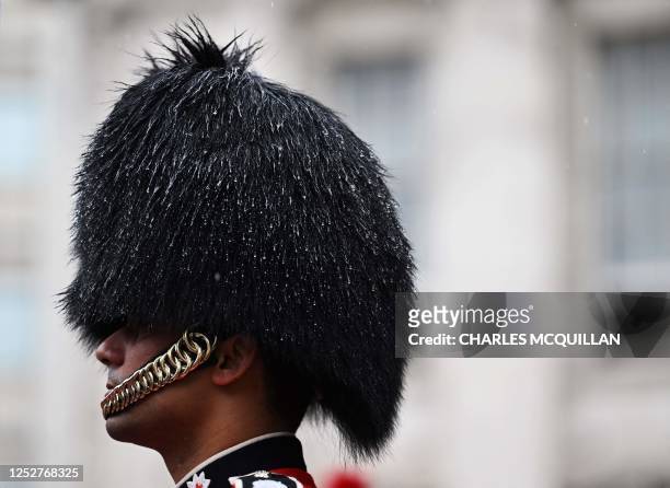 Royal guard takes part in the procession along the Mall during the Coronations of King Charles III and Queen Camilla on May 6, 2023 in London. - The...