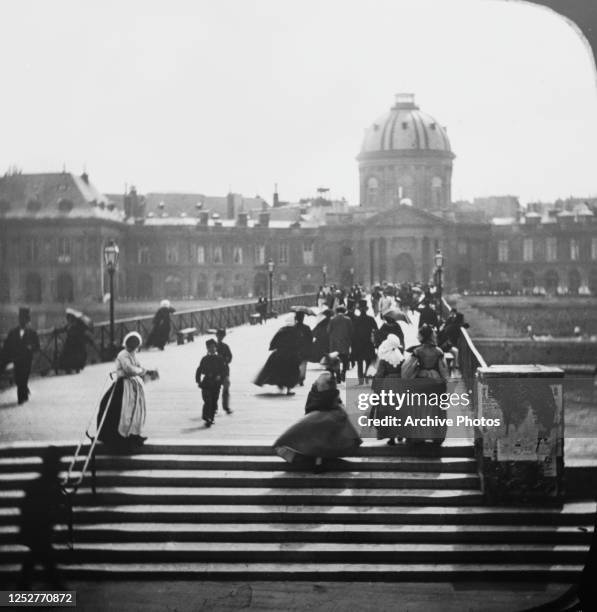 The Pont des Arts in Paris, France, with the Institut de France on the opposite side of the River Seine, circa 1890.