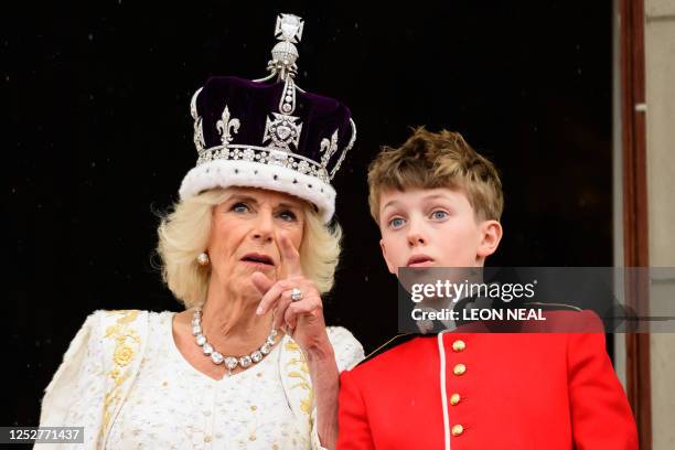 Queen Camilla talks to her grandson Freddy Parker Bowles on the Buckingham Palace balcony , in London, following her coronation, on May 6, 2023. -...