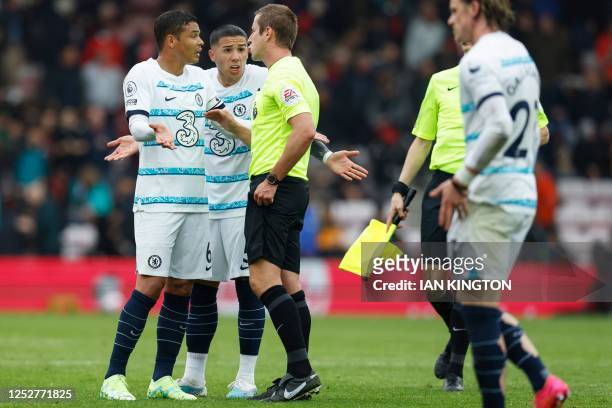 Chelsea's Brazilian defender Thiago Silva and Chelsea's Argentinian midfielder Enzo Fernandez gesture next to English referee John Brooks during the...
