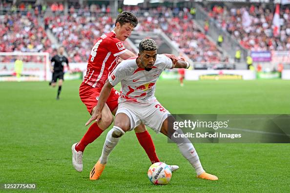 Merlin Roehl of SC Freiburg and Benjamin Henrichs of RB Leipzig ...