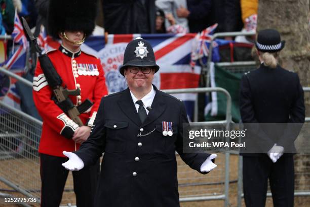 Police officer gestures on The Mall during the coronation of King Charles III and Queen Camilla on May 06, 2023 in London, England. The Coronation of...