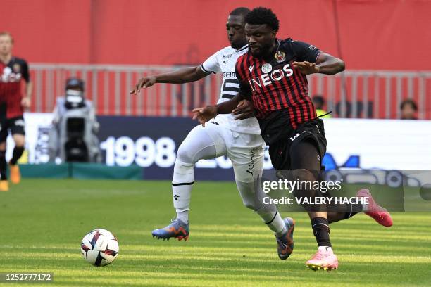 Nice's Nigerian forward Terem Moffi fights for the ball with Rennes' Malian defender Hamari Traore during the French L1 football match between OGC...