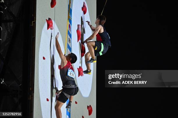 Singapore's speed climber Denzel Chua Jit Yi and China's speed climber Cao along compete in the Men's qualifying speed discipline at the IFSC...