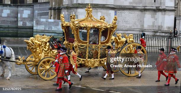 King Charles lll and Queen Camilla depart Westminster Abbey in the Gold State Coach following their coronation at Westminster Abbey on May 06, 2023...