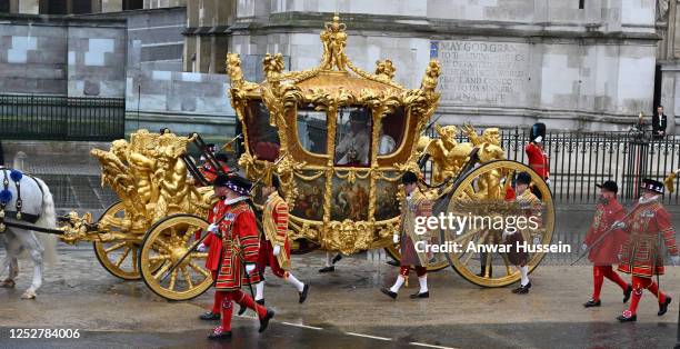 King Charles lll and Queen Camilla depart Westminster Abbey in the Gold State Coach following their coronation at Westminster Abbey on May 06, 2023...