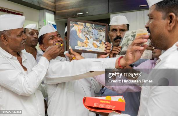 Mumbai dabbawalas feed sweets to one another in celebration after Prince Charles was crowned as King Charles III as the 40th monarch of Britain...