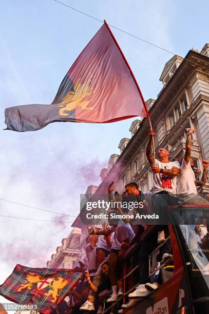 Players of Genoa reach the centre of town on a double-decker bus to celebrate after earning promotion in the Serie B match between Genoa CFC and...