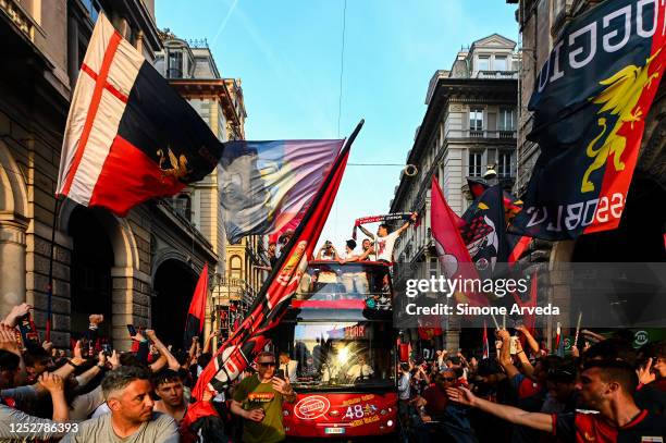 Players of Genoa reach the centre of town on a double-decker bus to celebrate after earning promotion in the Serie B match between Genoa CFC and...