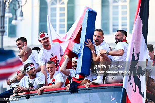 Players of Genoa reach the centre of town on a double-decker bus to celebrate after earning promotion in the Serie B match between Genoa CFC and...