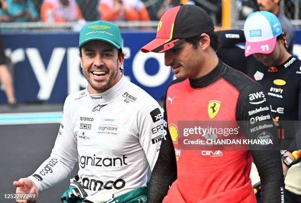 Ferrari's Spanish driver Carlos Sainz Jr., speaks with Aston Martin's Spanish driver Fernando Alonso after the qualifying session for the 2023 Miami...