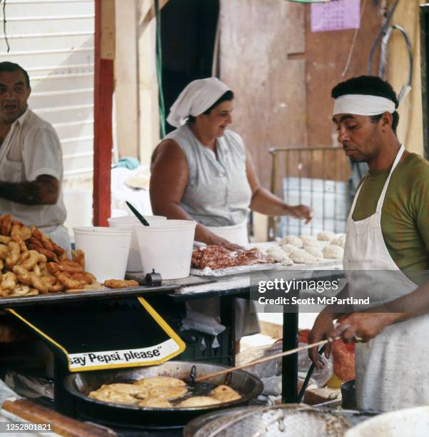 View of a vendors as they prepare food at a booth on Mulberry Street during the Feast Of San Gennaro Festival, in the Little Italy neighborhood, New...
