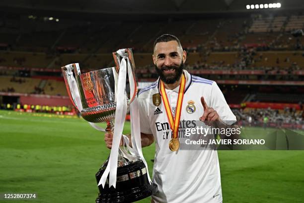 Real Madrid's French forward Karim Benzema holds the King's Cup trophy at the end of the Spanish Copa del Rey final football match between Real...