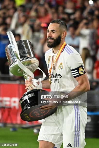 Real Madrid's French forward Karim Benzema holds the King's Cup trophy at the end of the Spanish Copa del Rey final football match between Real...