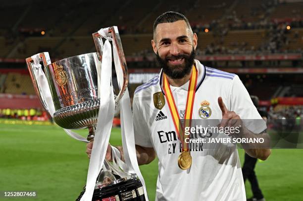 Real Madrid's French forward Karim Benzema holds the King's Cup trophy at the end of the Spanish Copa del Rey final football match between Real...