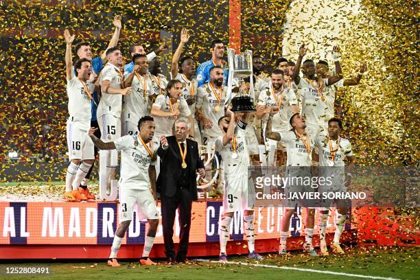 Real Madrid's players and Real Madrid's Italian coach Carlo Ancelotti celebrate with the King's Cup trophy at the end of the Spanish Copa del Rey...