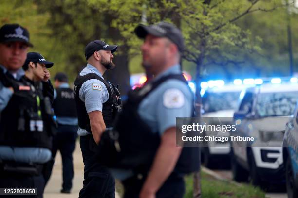 Chicago police and fire department personnel prepare for a fallen police officer to arrive at the Cook County Medical Examiner&apos;s office on West...
