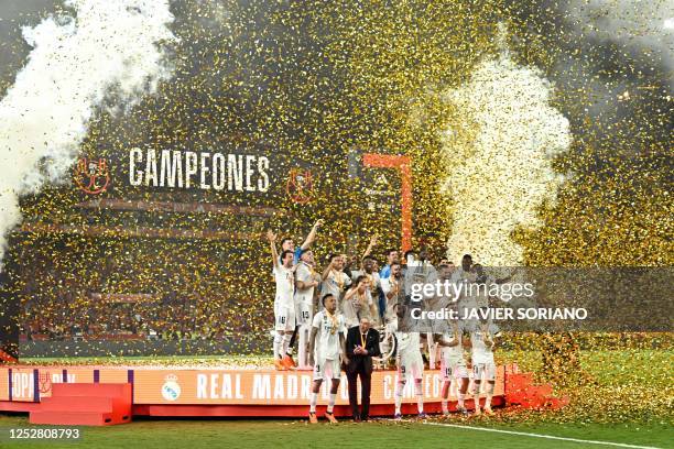 Real Madrid's players and Real Madrid's Italian coach Carlo Ancelotti celebrate with the King's Cup trophy at the end of the Spanish Copa del Rey...