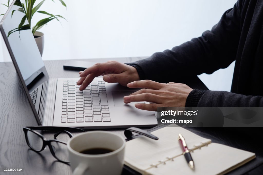 Japanese Man At Hand Operating A Computer High-Res Stock Photo - Getty ...