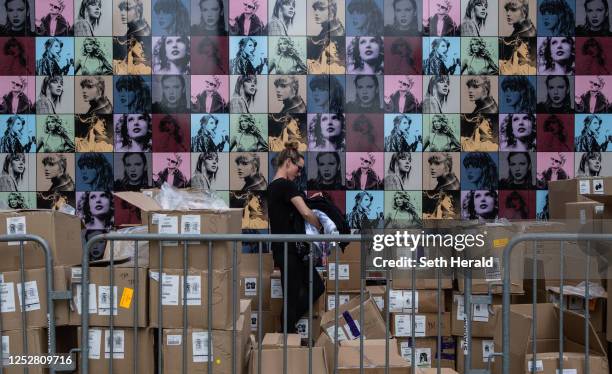 An employee unboxes official Taylor Swift merchandise outside of Nissan Stadium ahead of Swift's second night of performance on May 6, 2023 in...