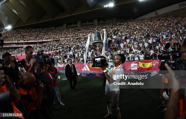 Rodrygo of Real Madrid lifts the trophy after winning the Copa del Rey final soccer match between Real Madrid and Osasuna at the La Cartuja Stadium...