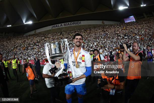 Thibaut Courtois of Real Madrid lifts the trophy after winning the Copa del Rey final soccer match between Real Madrid and Osasuna at the La Cartuja...