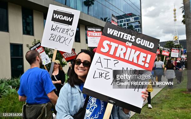 Writer Ilana Pena holds her sign on the picket line on the fourth day of the strike by the Writers Guild of America in front of Netflix in Hollywood,...