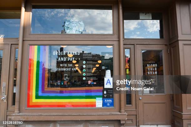Rainbow art is seen outside Starbucks in the West Village on June 26, 2020 in New York City. Due to the ongoing Coronavirus pandemic, this year's...