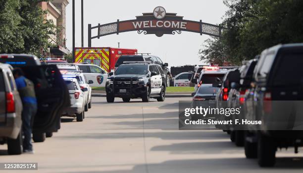 Emergency vehicles line the entrance to the Allen Premium Outlets where a shooting took place on May 6, 2023 in Allen, Texas. According to reports, a...