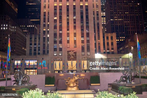 Pride flags line the rink at Rockefeller Center with a "New York Tough" sign projected on the 30 Rockefeller Plaza building on June 26, 2020 in New...