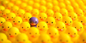 Large group of yellow rubber ducks, with one different contrasting purple rubber duck among the group, standing out from the crowd.