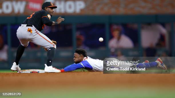 Ozzie Albies of the Atlanta Braves steals second and advances to third after Jorge Mateo of the Baltimore Orioles fails to bring in the ball...