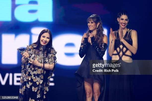 Ana Gabriel accepts the Billboard Living Legend Award while Hanna Nicole and Ashley Grace watch at Billboard Latin Women In Music held at the Watsco...
