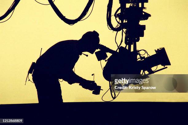 silhouetted cameraman - film set stock pictures, royalty-free photos & images