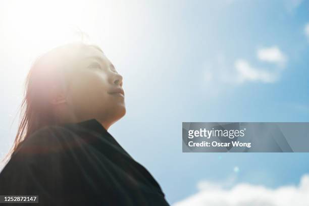 young woman having hope for the future - anticipation stock pictures, royalty-free photos & images