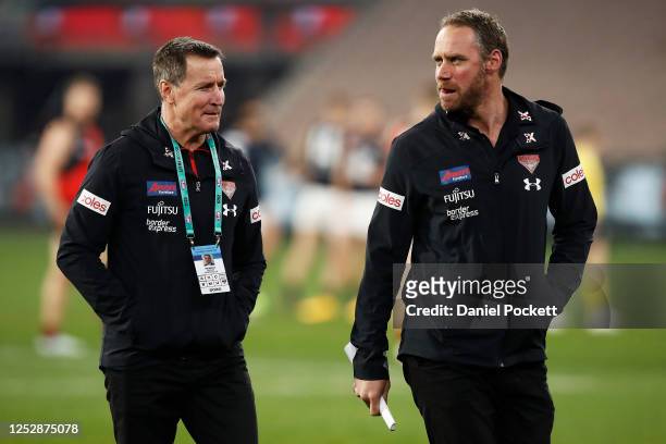 Bombers head coach John Worsfold and Bombers assistant coach Ben Rutten speak during the round 4 AFL match between the Essendon Bombers and the...
