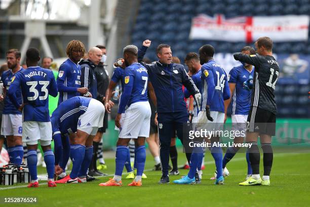 Neil Harris the manager of Cardiff City talks with his players during a water break in the Sky Bet Championship match between Preston North End and...