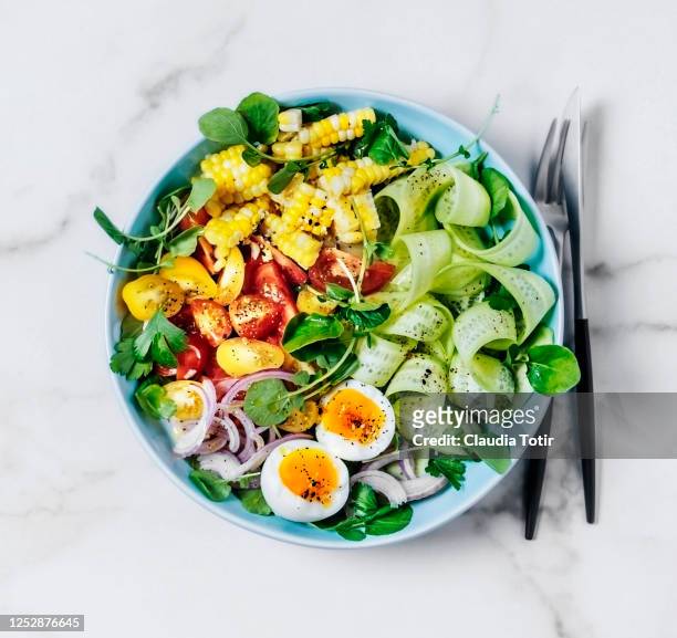 bowl of fresh salad with boiled eggs on white background - salad bowl stock pictures, royalty-free photos & images