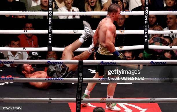 British boxer John Ryder falls to the mat during the fight against Mexican boxer Saul "Canelo" Alvarez for the WBA, WBC, IBF and WBO super...