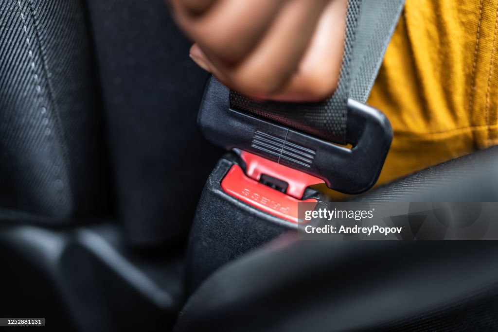 African Woman Buckling Up Seatbelt