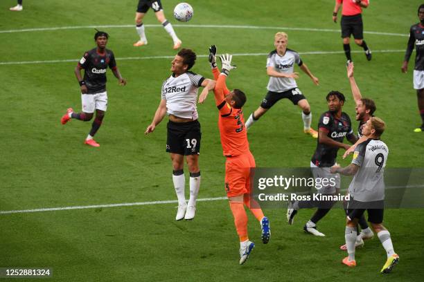 Chris Martin of Derby County challenges for the ball with goalkeeper Rafael of Reading during the Sky Bet Championship match between Derby County and...