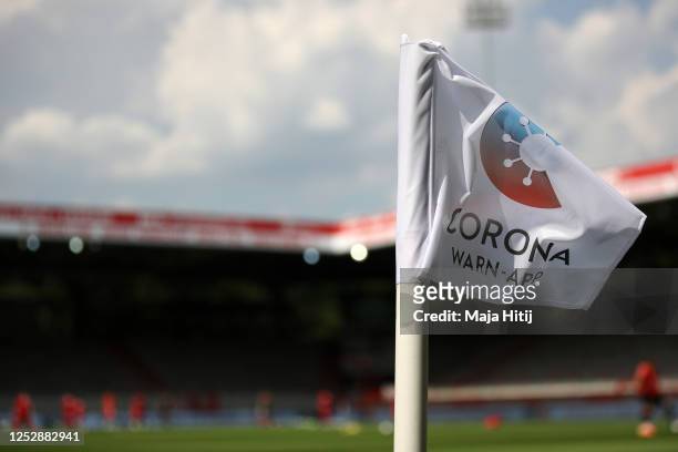 Detailed view of the Corona Warn-App on the corner flag during the Bundesliga match between 1. FC Union Berlin and Fortuna Duesseldorf at Stadion An...