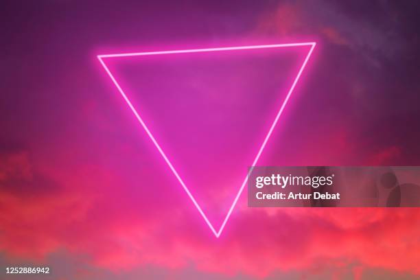 futuristic neon triangle in the burning sky with stunning pink colors. - beauty laser bildbanksfoton och bilder