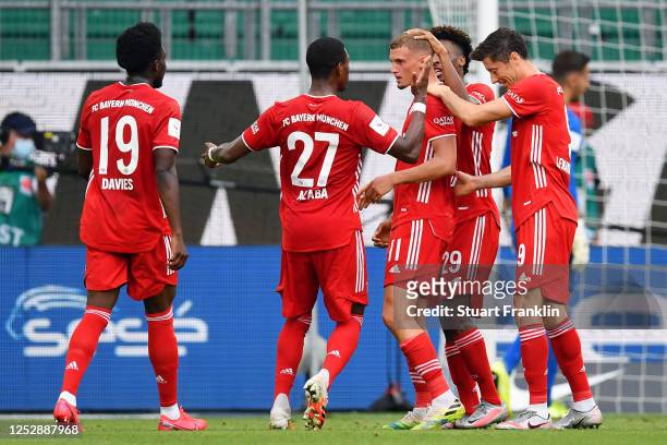 Mickael Cuisance of Muenchen celebrates his team's second goal with teammates during the Bundesliga match between VfL Wolfsburg and FC Bayern...