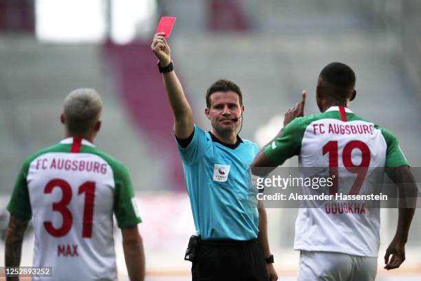 Philipp Max of FC Augsburg is sent off by referee Felix Brych and into the dressing room and is then then called back to the field after the VAR...
