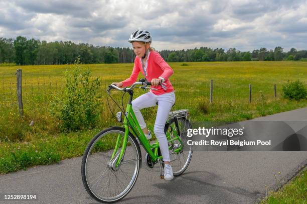 Princess Eleonore of Belgium rides a bike during a visit with King Philippe of Belgium, Queen Mathilde of Belgium, Princess Elisabeth of Belgium,...